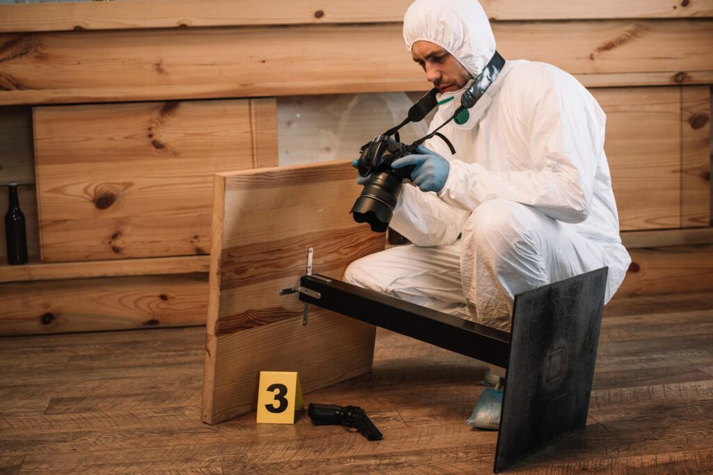 forensic investigator documenting evidence with camera at crime scene